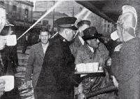 A Salvation Army worker provides tea for firemen and volunteers battling the fire