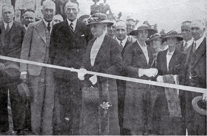Mrs Ell cutting the ribbon at the opening of the Summit Road by the Minister of Public Works, the Hon. R. Semple Mrs Ell cutting the ribbon at the opening of the Summit Road by the Minister of Public Works, the Hon. R. Semple