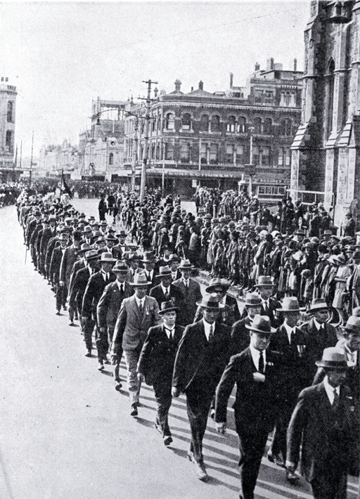 Returned soldiers in mufti and wearing medals marching past the Cathedral, Christchurch Returned soldiers in mufti and wearing medals marching past the Cathedral, Christchurch