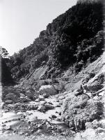 A roadman (?) sitting in the river bed beside the road through the Otira Gorge