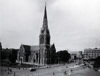 Pedestrians & trams in Cathedral Square, looking toward the Bank of New Zealand corner & the United Service Hotel, Christchurch