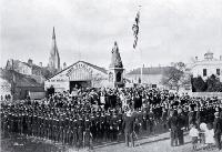 Public school cadets on Empire Day drawn up in front of the Victoria statue to salute the flag in Victoria Square, Christchurch