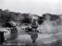 A young Maori girl washes clothes in the hot pools, Rotorua