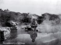 A young Maori girl washes clothes in the hot pools, Rotorua 