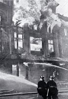 Firemen battling the blaze : directing jets on the furniture department.