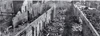 View of the central area of the gutted building : little remains except for the brick dividing walls and twisted roof iron.