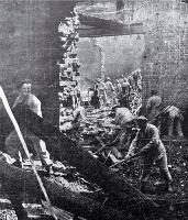 Soldiers work amongst the debris