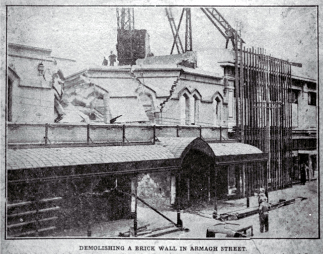 Demolishing a brick wall, T. Armstrong & Co. premises, corner of Colombo and Armagh Streets Demolishing a brick wall, T. Armstrong & Co. premises, corner of Colombo and Armagh Streets