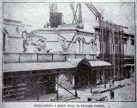 Demolishing a brick wall, T. Armstrong & Co. premises, corner of Colombo and Armagh Streets