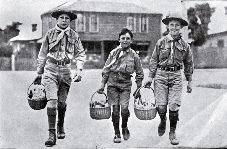 Cheerful boy scouts acting as messengers to distribute food and medicine to patients at their houses during the influenza epidemic Cheerful boy scouts acting as messengers to distribute food and medicine to patients at their houses during the influenza epidemic