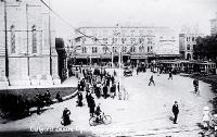 Pedestrians and trams in Cathedral Square, facing the United Services Hotel