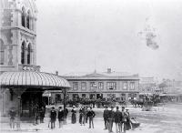 Hackney and hansom cabs at City Hotel crossing at the intersection of Colombo and High Streets with Fishers' building at left
