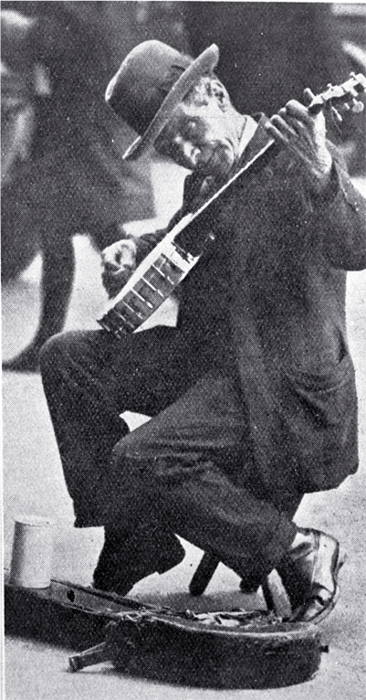 A busker with a banjo entertaining in Cathedral Square, Christchurch A busker with a banjo entertaining in Cathedral Square, Christchurch