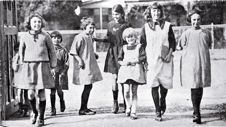 Are we downhearted? : girls merrily on their way to Phillipstown School on the day Christchurch schools reopened after five months due to the removal of restrictions on the assembly of children after the end of the infantile paralysis epidemic. Are we downhearted? : girls merrily on their way to Phillipstown School on the day Christchurch schools reopened after five months due to the removal of restrictions on the assembly of children after the end of the infantile paralysis epidemic.