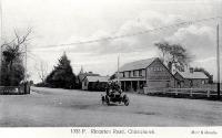 Car and woman driver near Nelson Moate & Co's premises, Riccarton Road, Christchurch, 1906