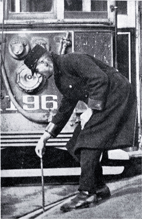 A tram conductor changes the points of the tram rails with a point bar A tram conductor changes the points of the tram rails with a point bar
