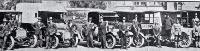Some members of the St John Ambulance Brigade with the vehicles used as ambulances during the influenza epidemic
