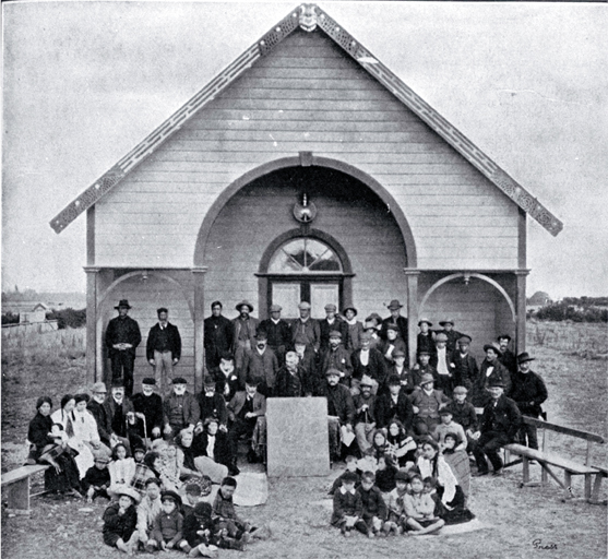 "The natives assembled in front of the Arowhenua Pa meeting house, Temuka" "The natives assembled in front of the Arowhenua Pa meeting house, Temuka"