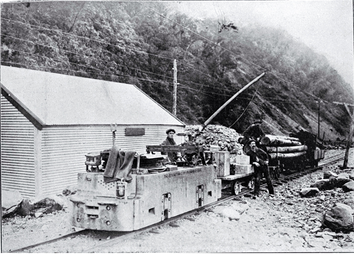 Electric locomotion with a train load of explosives and timber to be used in the construction of the Arthur's Pass Tunnel Electric locomotion with a train load of explosives and timber to be used in the construction of the Arthur's Pass Tunnel