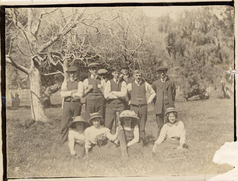 Group outdoors with cricket bat Group outdoors with cricket bat