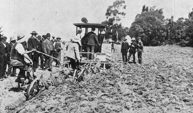 The engine drawing two four-furrow disc ploughs in bad twitch land - ploughing over six inches in depth.