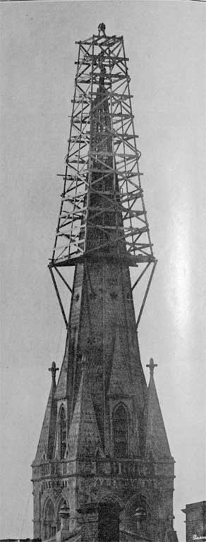 A risky position : making ready to place the cross on the summit of Christchurch Cathedral spire. A risky position : making ready to place the cross on the summit of Christchurch Cathedral spire.