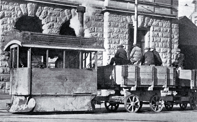 A Kitson steam tram runs past the Government Buildings in Cathedral Square with tramways workers on board A Kitson steam tram runs past the Government Buildings in Cathedral Square with tramways workers on board
