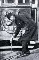 A tram conductor changes the points of the tram rails with a point bar