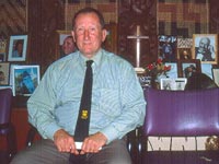 Dr Terry Ryan seated inside surrounded by tupuna, February 2004
