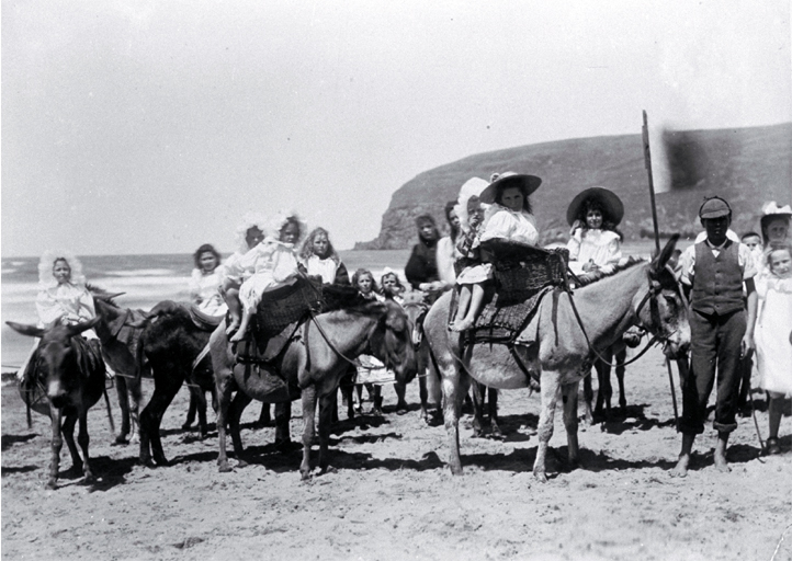 Children taking donkey rides on Sumner beach, Christchurch Children taking donkey rides on Sumner beach, Christchurch