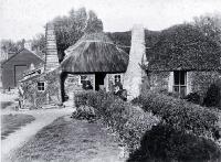 The Shand homestead at Te Whakaru : Mrs Shand seated in front of house with two daughters, Jennie and Susan.