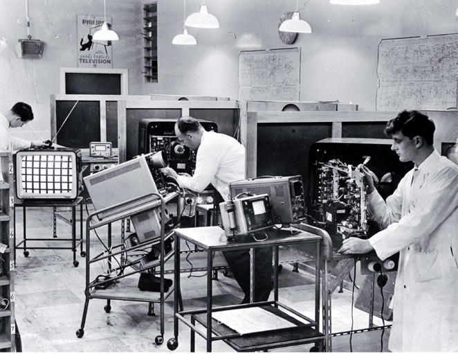 Technicians at work in the service department of the television section at Philips Electrical Industries Ltd. Technicians at work in the service department of the television section at Philips Electrical Industries Ltd.