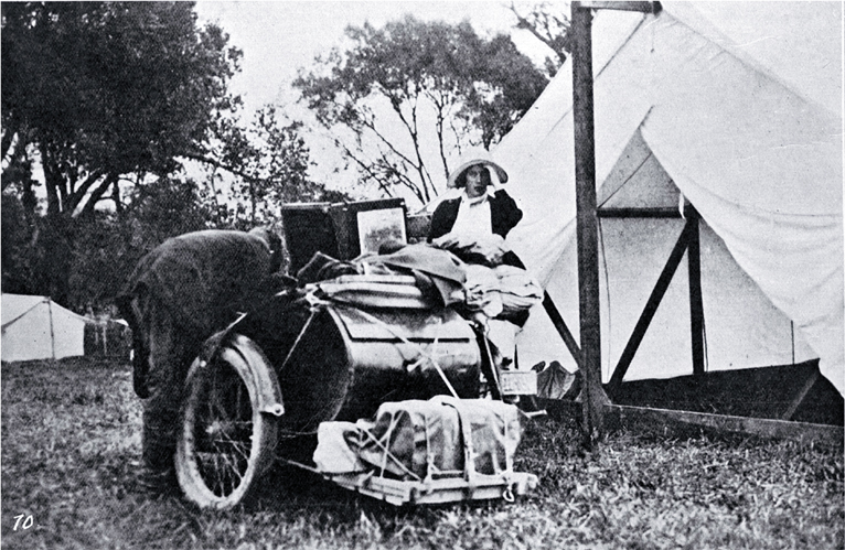 A camping holiday ideal for health and pleasure : touring by motorcycle, unpacking side-car in front of the tent. A camping holiday ideal for health and pleasure : touring by motorcycle, unpacking side-car in front of the tent.