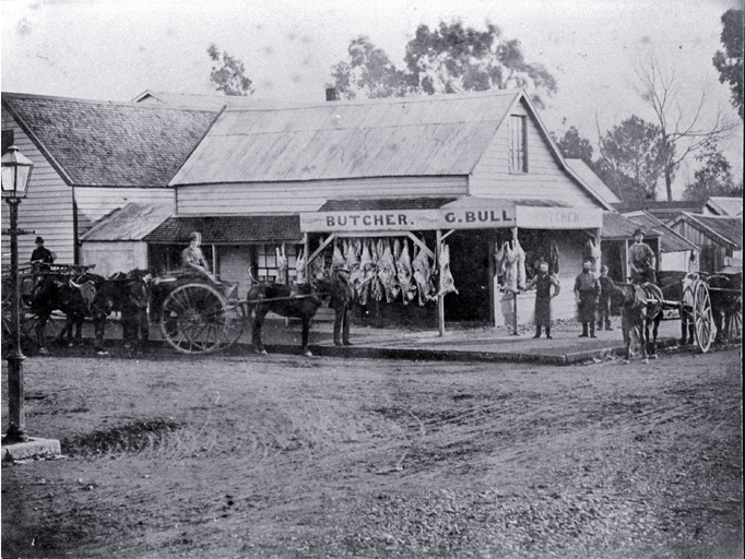 Meat hangs outside G. Bull's butchery in Cashel Street, Christchurch, with delivery carts waiting Meat hangs outside G. Bull's butchery in Cashel Street, Christchurch, with delivery carts waiting