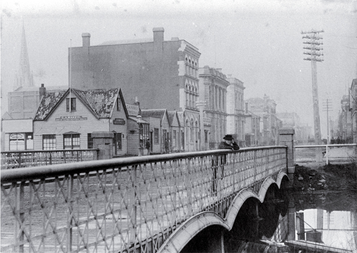 A boy leans on the Hereford Street bridge, Christchurch, looking to the east A boy leans on the Hereford Street bridge, Christchurch, looking to the east