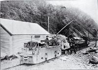 Electric locomotion with a train load of explosives and timber to be used in the construction of the Arthur's Pass Tunnel 